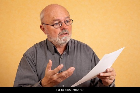 Elderly man, 59, holding a letter, bill, questioning look, shocked expression-stock-foto
