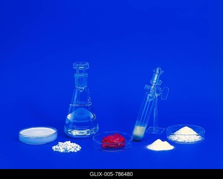 Red and white chemicals in petri dishes and test tubes-stock-foto