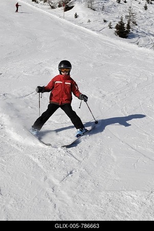 Child skiing, ski-run. alpine skiing with helmet, safety-stock-foto