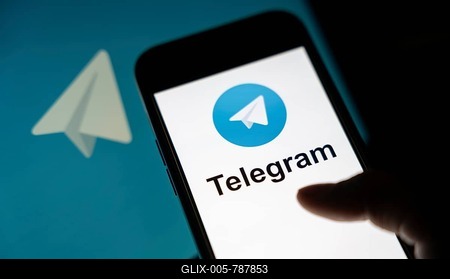 The social media Telegram messenger logo is being displayed on a smartphone screen and on a computer screen-stock-foto