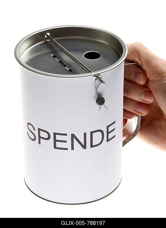 Donation box labeled Spende, German for donation, with slots for coins and bills, with a security seal to protect against unlawful opening-stock-foto