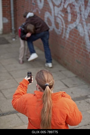 Two boys fighting and being filmed by a girl with her mobile phone, reenactment-stock-foto