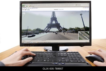 Person sitting at a computer working with Google Street View via Google Maps, using the internet, screen showing images of streets in Paris and the Eiffel Tower-stock-foto
