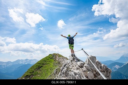 Mountaineer on a ridge on a secured fixed rope route, stretching his arms in the air, Mittenwalder Höhenweg, view of mountain panorama, Karwendel Mountains, Mittenwald, Bavaria, Germany-stock-foto
