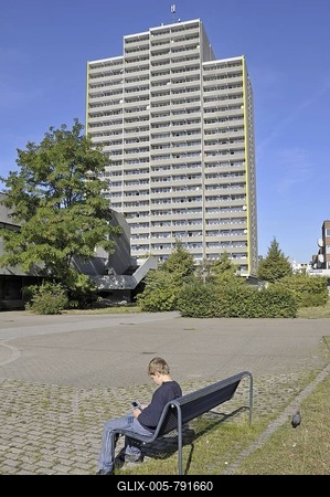 Boy, 9, playing with his Nintendo in front of a high-rise apartment building, satellite town of Chorweiler in Cologne, North Rhine-Westphalia, Germany, Europe-stock-foto