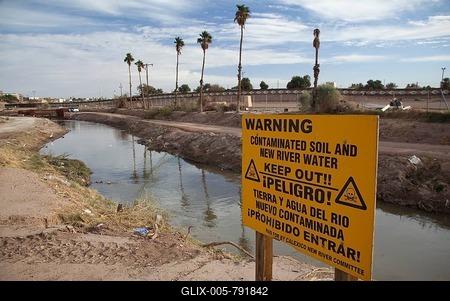 The heavily-polluted New River, as it enters the USA from Mexico; the pollution results from a mix of untreated sewage, agricultural runoff, and industrial waste, Calexico, California, USA-stock-foto