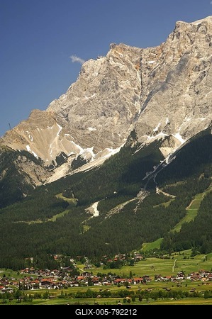 The limestone wall of Mt. Zugspitze with the top station of the Tyrolean Zugspitze Cable Cartowers above the valley town of Ehrwald, Wettersteingebirge range, Tyrol, Austria, Europe-stock-foto