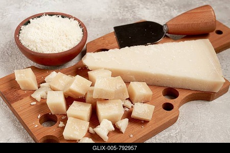 Freshly sliced and grated cheese, parmesan cheese, Gran gusto. Grana padano. on a wooden chopping board, rustic style, no people-stock-foto
