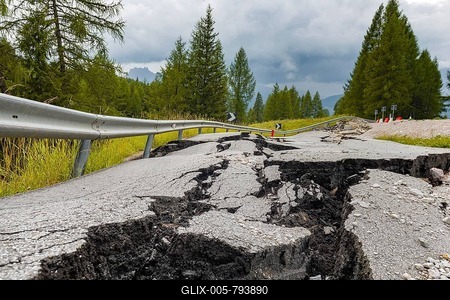Broken road with cracks in the road surface, broken roadway of a mountain road, Belluno, Italy-stock-foto