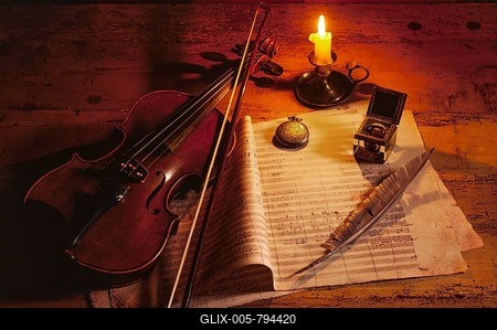Violin with music sheet and quill by candlelight-stock-foto