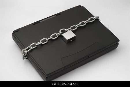 Chain and Padlock Securing a Laptop Computer-stock-foto
