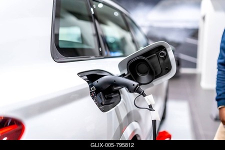 Close up of a charging electric car in a dealership, showcasing sustainable transportation-stock-foto