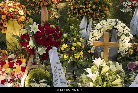 Fresh grave decorated with countless flowers at a cemetery in Germany-stock-foto