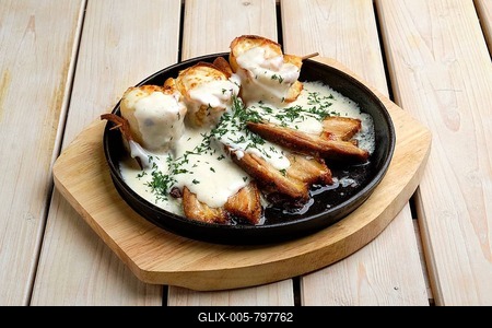 Thin pancakes on skewer stuffed with cheese and served with fried bacon-stock-foto