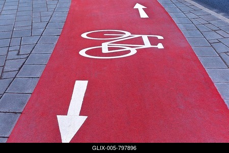 Red cycle path with white markings, bicycle and direction arrows, Bavaria, Germany-stock-foto