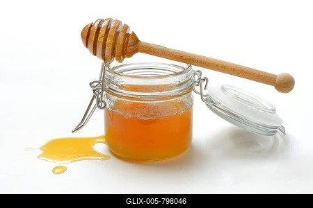 Bee honey in glass and honey spoon, blossom honey, white background-stock-foto