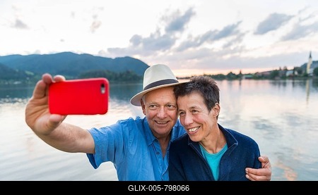 Man and woman smiling, taking photo with mobile phone, selfie, Schliersee, Upper Bavaria, Bavaria, Germany-stock-foto