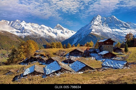 Alpine huts in Val d'Hérens, behind them snow-covered Valais Alps, Canton Valais, Switzerland-stock-foto