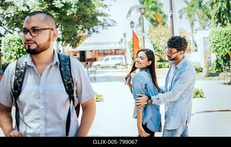 Disloyal girlfriend looking at another guy on the street. Unfaithful girlfriend looking at another man on the street, Unfaithful girl looking at another man on street and her boyfriend claims her-stock-foto