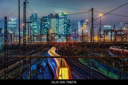 Driving train in front of Frankfurt am Main central station in front of the skyline, colorfully illuminated, Frankfurt, Hesse, Germany-stock-foto