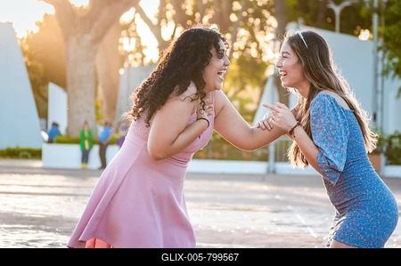 Two happy girls laughing on the street, two women talking and laughing on the street, two women having fun-stock-foto