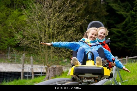 Young women on a summer toboggan run, Steinwasenpark in Oberried, Black Forest, Baden-Württemberg, Germany-stock-foto