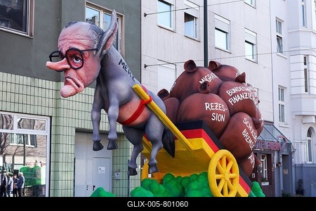 Chancellor candidate Friedrich Merz as a donkey figure in front of a cart with heavy sacks, debt brake, recession, migration, papier-mâché figure, theme float by Jacques Tilly, Rosenmontagszug 2025, Düsseldorf, Rhineland, North Rhine-Westphalia, Germany-stock-foto