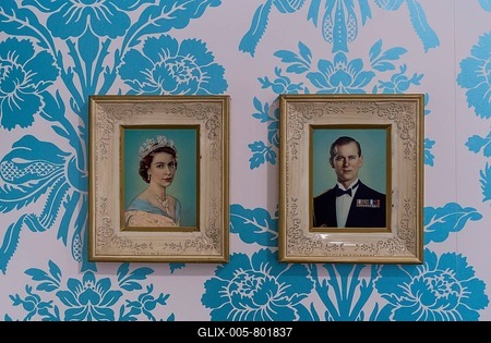 Pictures of Queen Elizabeth II and Prince Philip on wall with floral wallpaper, Stuttgart, Germany, Europe-stock-foto