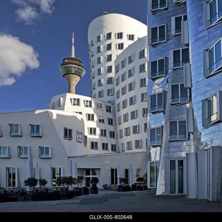 The Neue Zollhof with two Gehry buildings and the Rhine Tower, Düsseldorf, North Rhine-Westphalia, Germany-stock-foto