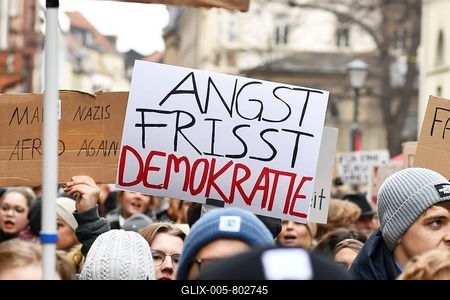 Heidelberg, Germany - February 12th 2025: Person holding up sign with text 'Fear eats democracy in crowd at protest against far-right-stock-foto
