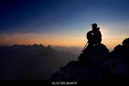 Mountaineer sitting on a rock on Großer Krottenkopf Mountain at dusk, Allgäuer Alpen, Tyrol, Austria-stock-foto