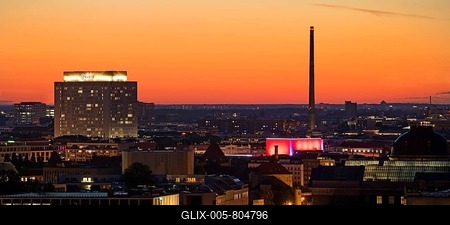 Charité high-rise hospital and the chimney of the Vattenfall combined heat and power plant Scharnhorststraße in the sunset, Berlin, Germany-stock-foto