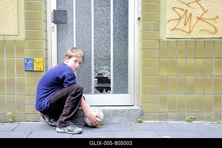 Ten-year-old boy and the shot pane of a front door, Germany, Europe-stock-foto