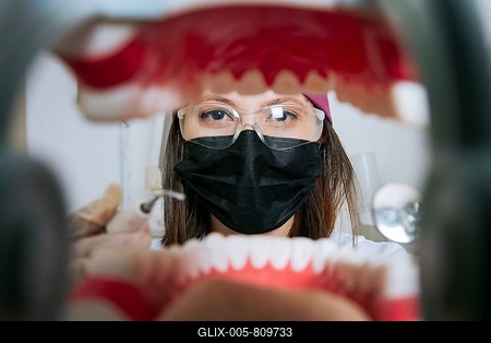 Woman dentist cleaning a mouth inside view, Inside view of a mouth checked by a dentist, a female dentist checking a patient. dentist checking a mouth, a dentist cleaning teeth-stock-foto