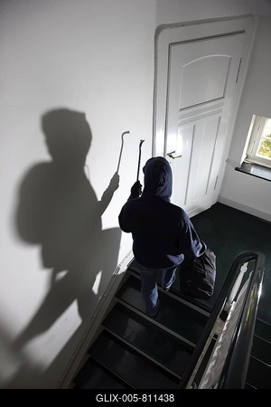 Burglary, burglar on a staircase of an apartment house during the day-stock-foto