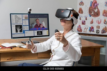 Symbol photo for telemedicine, doctor in a practice, with VR glasses, Virtual Reality, 3-D presentation of an MRT result, communicates with the patient via webcam, Germany-stock-foto