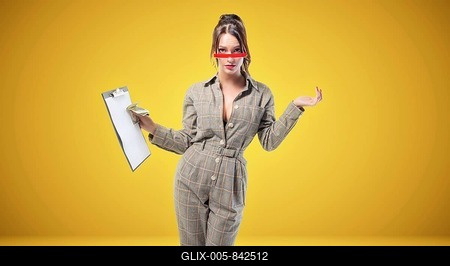 Charming woman in a suit stands in the studio on a yellow background. Coaching and mentoring concept.-stock-foto