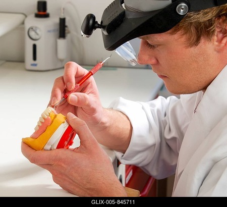 Dental technician, dental technology, modelling on lower jaw partial dentures with wax, Germany-stock-foto