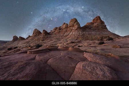 A breathtaking view of jagged rock formations under a vast, starry night sky, capturing the beauty of a remote desert landscape in Coyote Buttes, Arizona. Perfect for nature and travel enthusiasts-stock-foto