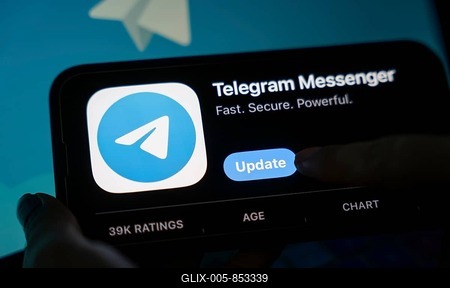 The social media Telegram messenger logo is being displayed on a smartphone screen and on a computer screen-stock-foto