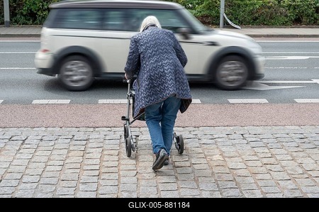 Elderly woman with rollator wants to cross the road, in front of her a passing car, Erlangen, Bavaria, Germany-stock-foto