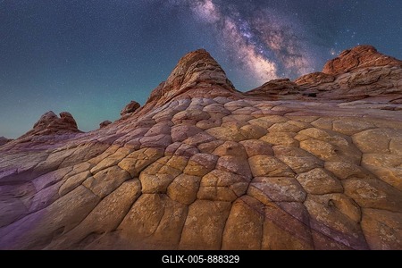 A breathtaking view of the Milky Way illuminating a unique, textured rock formation in Coyote Buttes, Arizona. The night sky is filled with stars, showcasing nature wonder-stock-foto