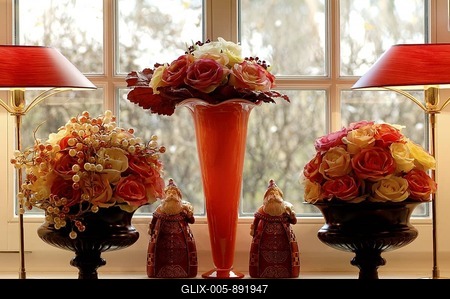Three flower vases with rose blossoms in front of a window-stock-foto