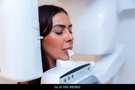 Patient is undergoing a dental x ray scan with advanced equipment in a modern dental clinic, ensuring precise diagnostics for optimal treatment-stock-foto