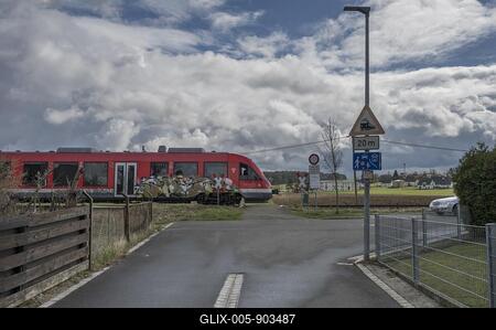 Suburban railway crossing an ungated level crossing in a village, Forth, Middle Franconia, Bavaria, Germany-stock-foto