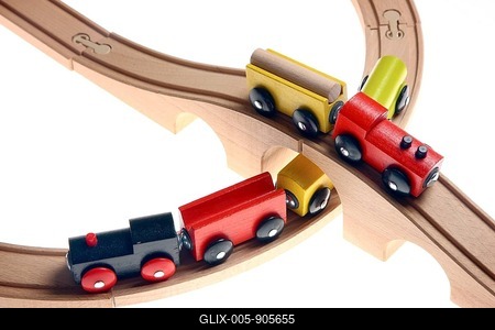 Two toy wooden trains crossing each other at a railroad crossing, railway bridge-stock-foto