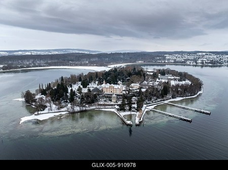 The wintry and snowy Mainau island in Lake Constance with the pier and the baroque Mainau Castle, built between 1739 and 1746, behind it the village of Litzelstetten, aerial view, district of Konstanz, Baden-Württemberg, Germany-stock-foto