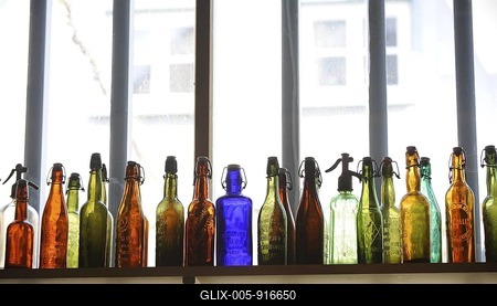 Coloured bottles on a shelf-stock-foto