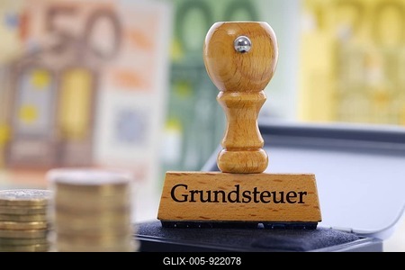 Stamp with the writing Grundsteuer real estate tax-stock-foto