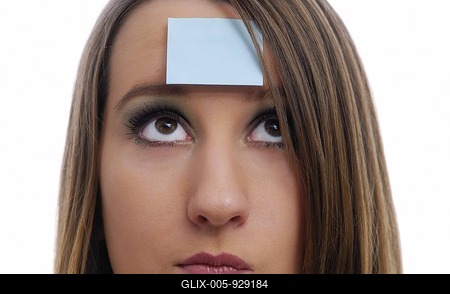 Pensive woman with a piece of paper on her forehead, playing the game "Who am I?"-stock-foto